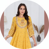 Circular portrait of Mariam Saleh, a young woman with a creative expression, wearing the embroidered MALIKA dress. The backgr